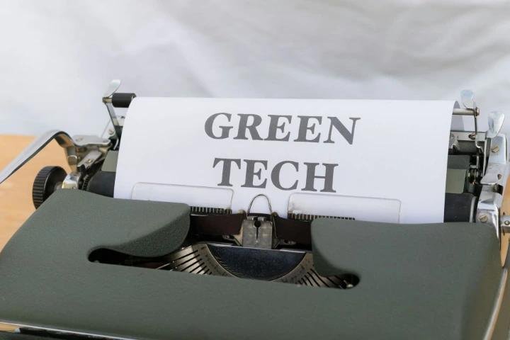 an old typewriter with a green tech sign on it